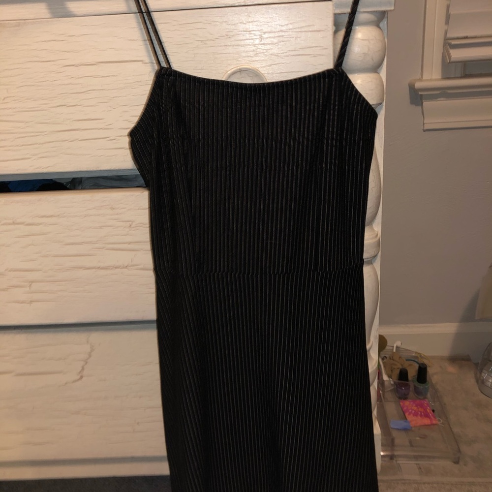 A mini black dress with white thin stripes.